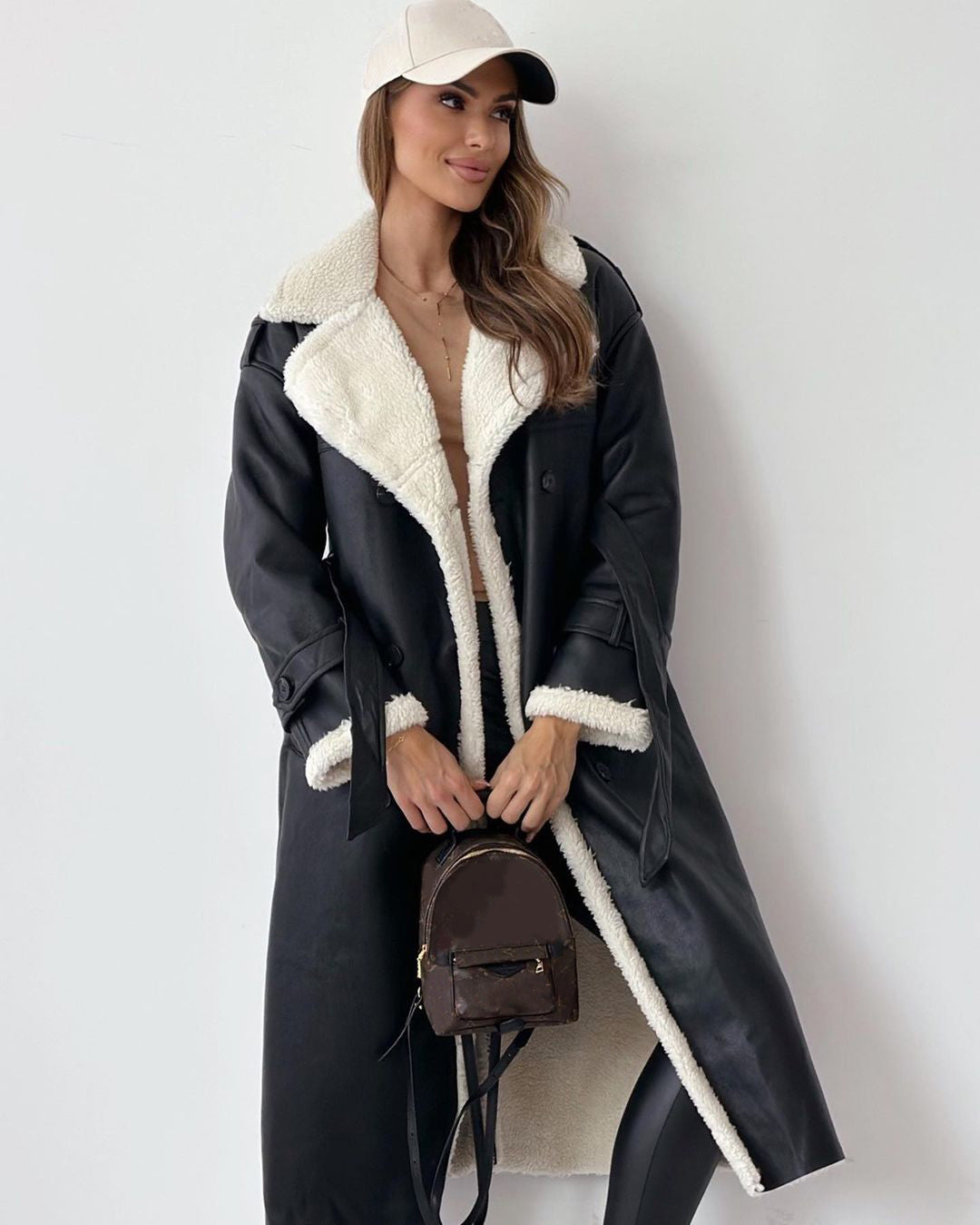 Women’s double-breasted winter trench coat with belt and lapel.