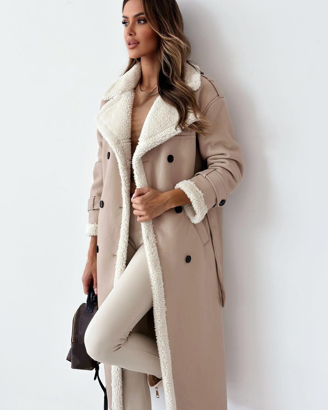 Women’s double-breasted winter trench coat with belt and lapel.