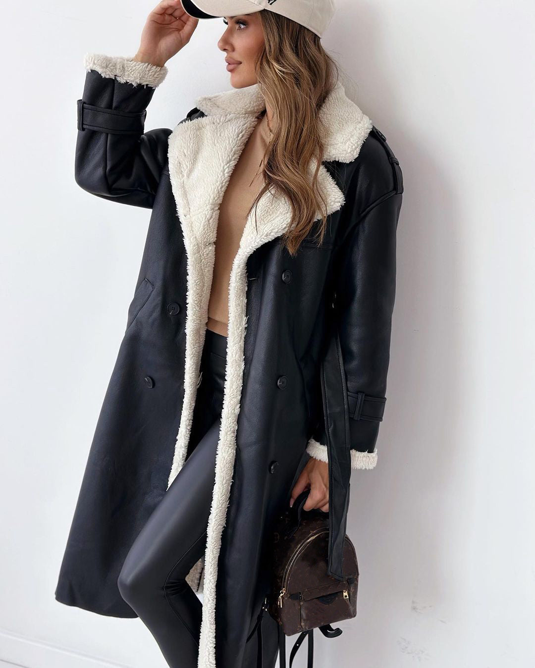 Women’s double-breasted winter trench coat with belt and lapel.